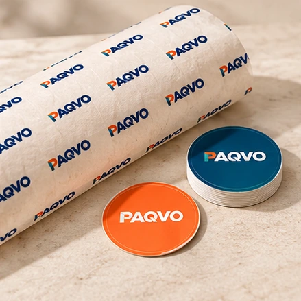 Roll of printed wrapping paper with round branded labels
